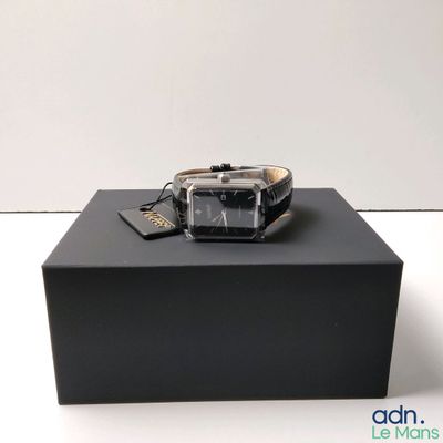 a watch sitting on top of a box on a table