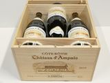 bottles of wine in a wooden box on a white surface