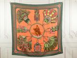 an orange and green scarf hanging on the wall
