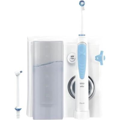 une brosse à dents avec, à côté, un tube de dentifrice et un distributeur de dentifrice
