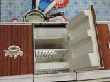 an open refrigerator with dishes and utensils in it