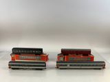 pair of red and black train cars sitting on top of a white table