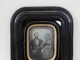 framed photograph of a man and a woman in a black frame