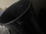 a black bucket sitting on top of a stove
