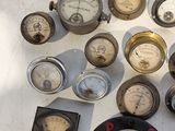 many different types of gauges displayed on a table