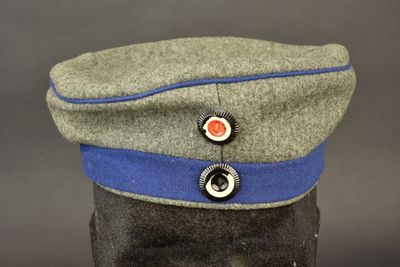 a grey hat with a blue band on top of it