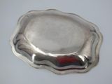 a silver plate with a red stripe on it