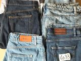 three pairs of levi ' s jeans are stacked on top of each other