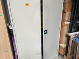 a white refrigerator in the middle of a pile of boxes