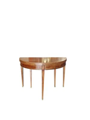 an oval dining table with two legs and a wooden top