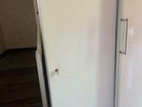 two white refrigerators sitting in a kitchen next to each other