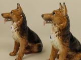 two figurines of a dog sitting next to each other