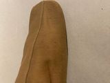 a close up of a person ' s foot wearing a pair of brown shoes
