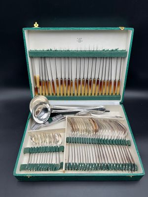 a green case with silverware in it on a table