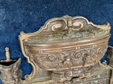 a very old metal object that is sitting on a blue cloth