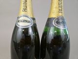two bottles of champagne are sitting on a table