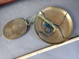 a small metal object with a rope around it and a coin