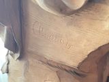 a statue of a dog sitting on top of a wooden table