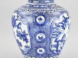 a blue and white vase with a design on it