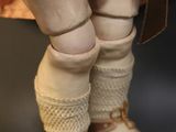 a close up of a doll wearing a pair of shoes