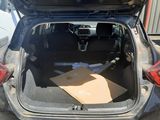 a car with its trunk open and a box in the trunk