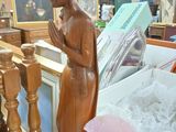 a statue of a woman that is sitting on a table