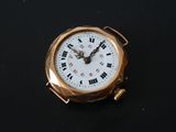 a gold pocket watch with roman numerals on it