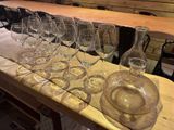 many wine glasses and a decanter on a table