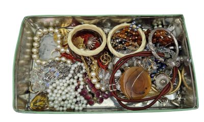 a box of assorted jewelry on a white surface