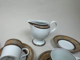 a lot of cups and saucers sitting on a table