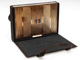 a black suitcase with a handle on a white surface