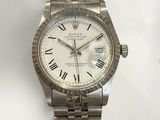 an image of a wrist watch with roman numerals on a bracelet