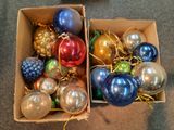 many different colored ornaments in a box on the floor