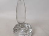 a glass vase with a horse on it on a table