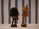 two stuffed animals that are standing next to each other