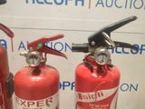 two fire extinguisors sitting next to each other