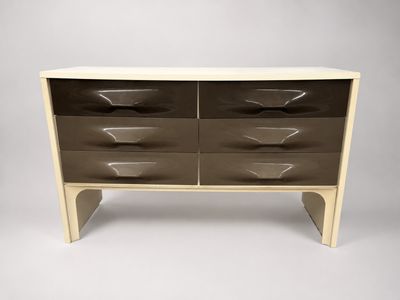 a white and brown chest of drawers on a grey background