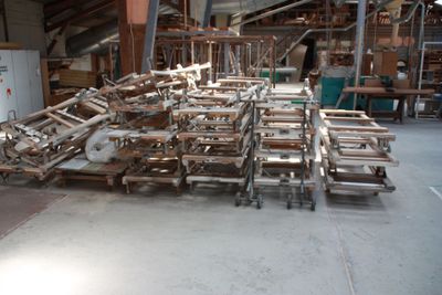 many pieces of wood on the floor in the warehouse