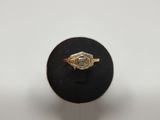 a close up of a gold ring on a black ring stand