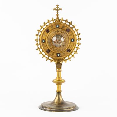 an image of a golden clock on a stand on a white background