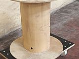 a picture of a wooden spool on a dolly