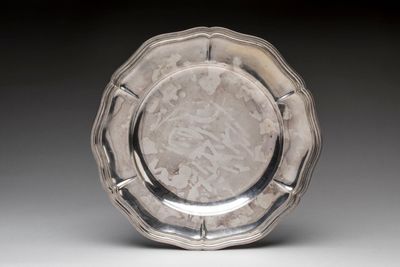 a silver plate that is sitting on a table