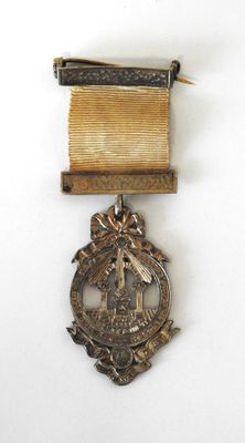 an image of a medal with a ribbon on a white surface