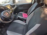 the interior of a small car with a steering wheel and a dashboard