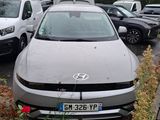 a silver car parked in a parking lot with other cars in the background