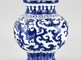 a blue and white vase sitting on a table