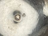a silver bowl with a hole in the middle of it