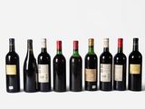a group of bottles of wine sitting on top of a white surface