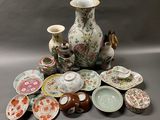 many different types of vases and plates on the table