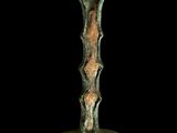 an image of a bronze vase with a curved handle